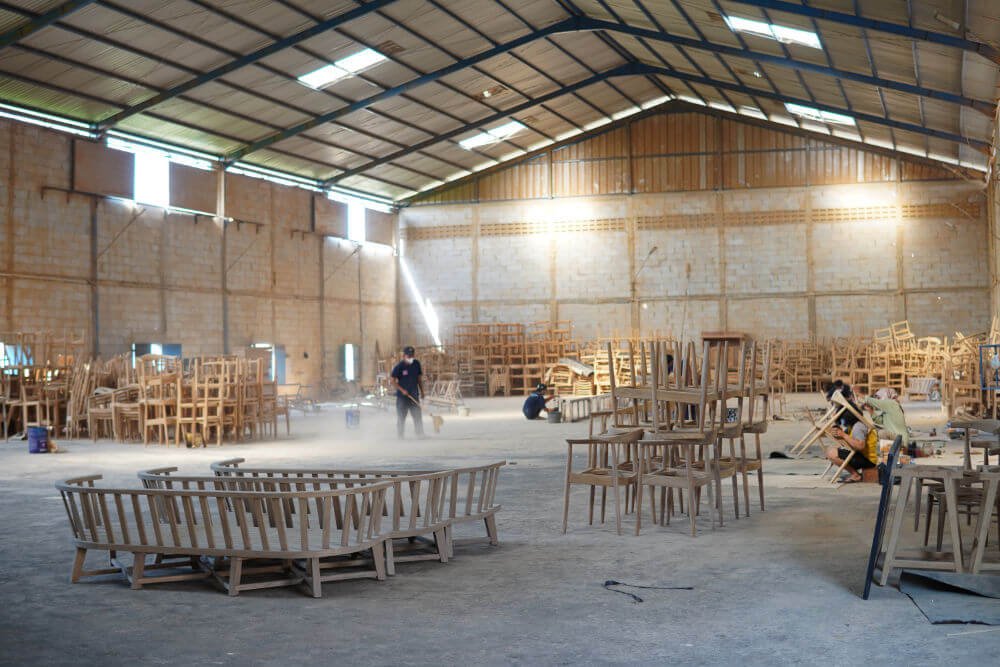 Craftsmen assembling solid wood furniture inside the MPP Furniture factory in Cirebon, Indonesia